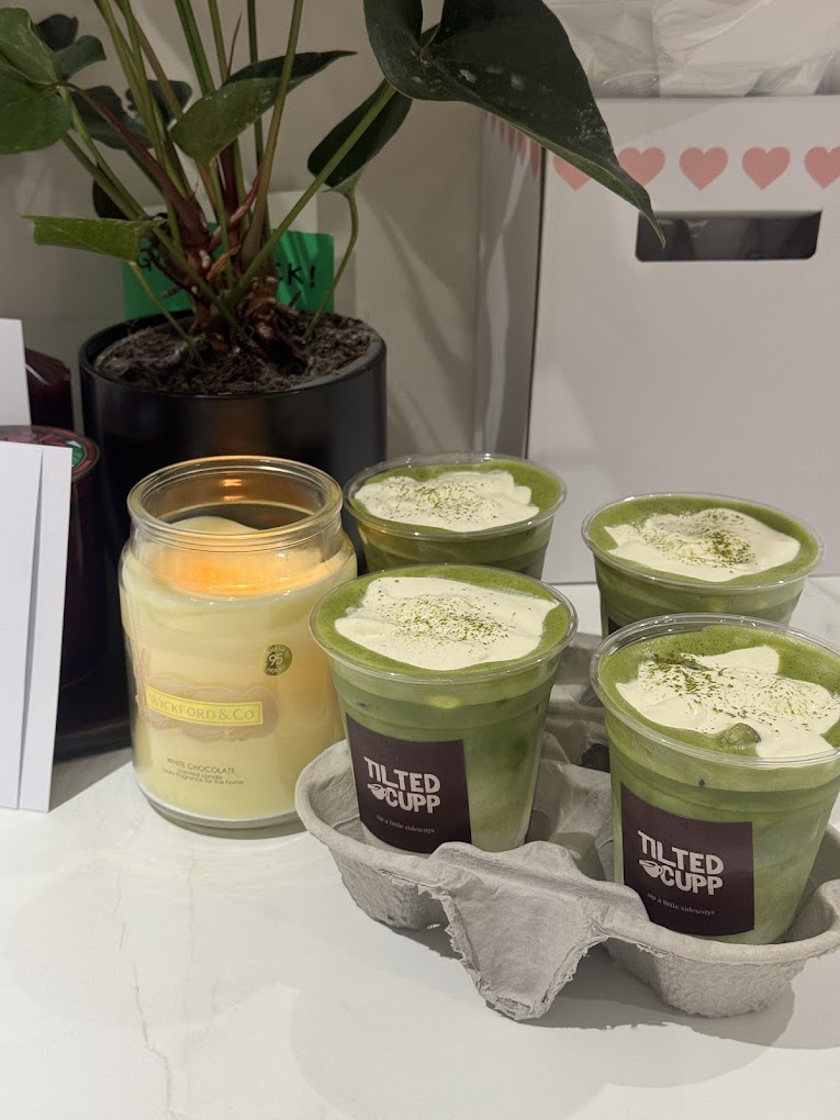 Four matcha cups with cold foam in a takeaway carrier